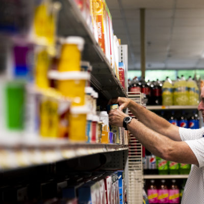 Wollastons grocery and delicatessen manager Bob Peredna organizes the shelves in his Huntington Avenue store on Thursday, July 14, 2022.