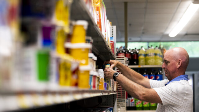 Wollastons grocery and delicatessen manager Bob Peredna organizes the shelves in his Huntington Avenue store on Thursday, July 14, 2022.