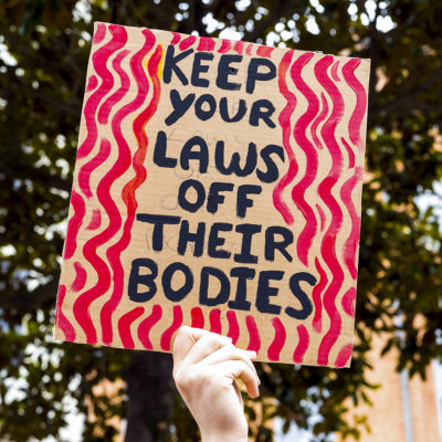 A placard, Keep your, Laws off their Bodies. Rally in support of the right to abortion in the United States in Toulouse. In support of the American people who are suffering from the Supreme Court's overturning of Roe v. Wade, a ruling that guaranteed the right to abortion in all states, and in solidarity with women around the world. France, Toulouse June 26, 2022.