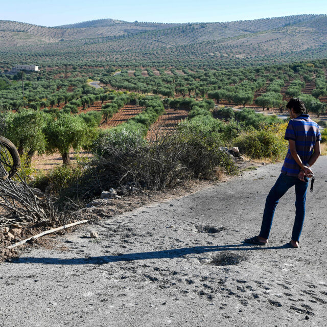 A man inspects the damage at the site where a US drone strike killed Maher al-Agal, a leader in the Islamic State militant group, near the village of Khaltan, near Jindayris in northern Syria, on July 12, 2022. - US officials called the leader of the Islamic State militant group in Syria was killed Tuesday in a drone strike, the Pentagon said. Maher al-Agal was killed while riding a motorcycle near Jindires in northern Syria, and one of his top aides was 