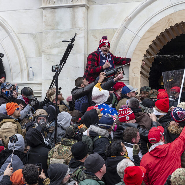 Rioters clash with police trying to enter Capitol building through the front doors in Washington, DC on January 6, 2021.