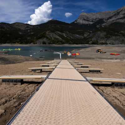 A picture taken on August 21, 2022, shows boarding pontoons on Lake Serre-Poncon in the French Alps, as water level decreased 14 meters due to drought.