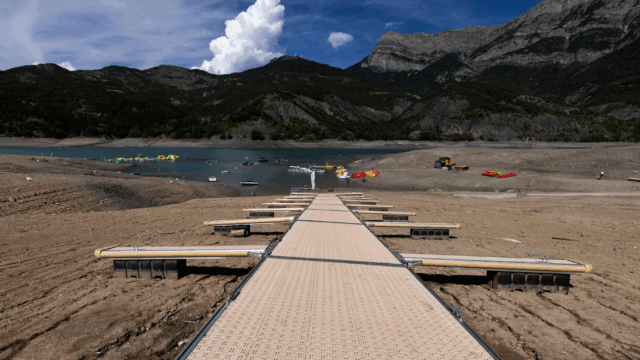 A picture taken on August 21, 2022, shows boarding pontoons on Lake Serre-Poncon in the French Alps, as water level decreased 14 meters due to drought.