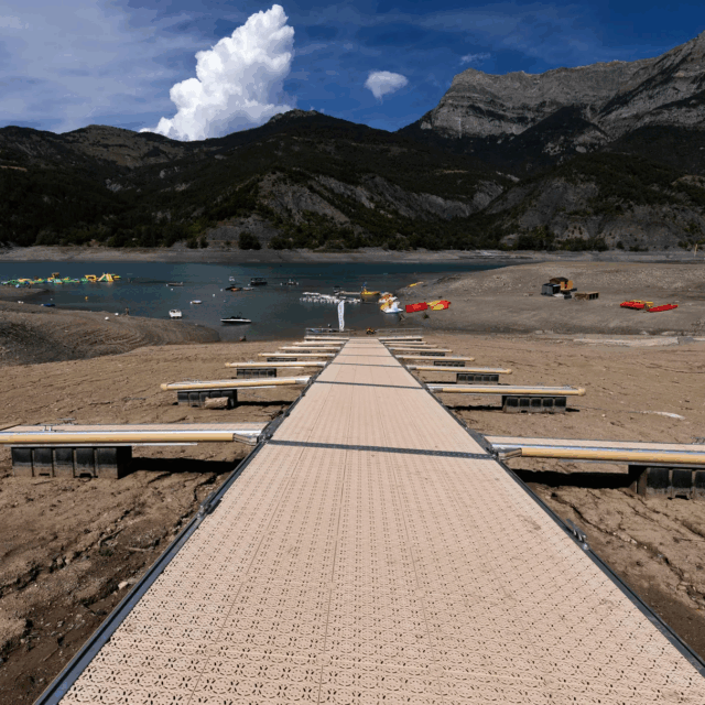 A picture taken on August 21, 2022, shows boarding pontoons on Lake Serre-Poncon in the French Alps, as water level decreased 14 meters due to drought.