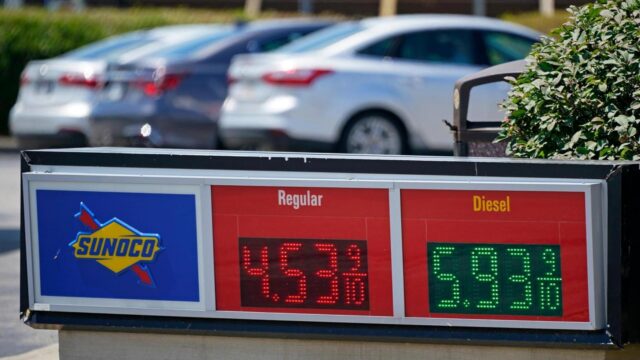 FILE – Gas prices are displayed at a Sunoco gas station along the Ohio Turnpike near Youngstown, Ohio, Tuesday, July 12, 2022. Thanks largely to falling gas prices, the government’s inflation report for July, to be released Wednesday, Aug. 10, 2022, will probably show that prices jumped 8.7% from a year earlier, according to a survey of economists by data provider FactSet.