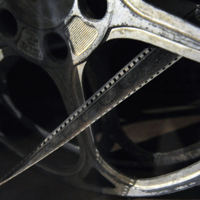 ADVANCE FOR MONDAY AUG. 22 - In this Aug. 5, 2016 photo, Movie reels and old films left over from the Old Texas Theater's years as a movie house sit on display in a cabinet within the Ballinger venue in Ballinger, Texas. Things have been up and down for the Old Texas Theater over the years. Now, the venue is coming back once again.