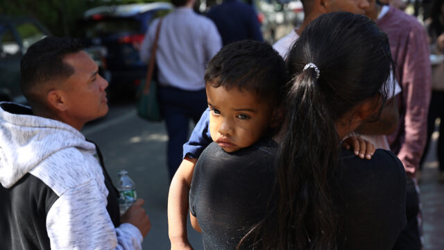 Martha's Vineyard, MA - September 15: A mother and child spent some time outside the St. Andrew's Parrish House where migrants were being fed lunch with donated food from the community. Two planes of migrants from Venezuela arrived suddenly Wednesday night on Martha's Vineyard.