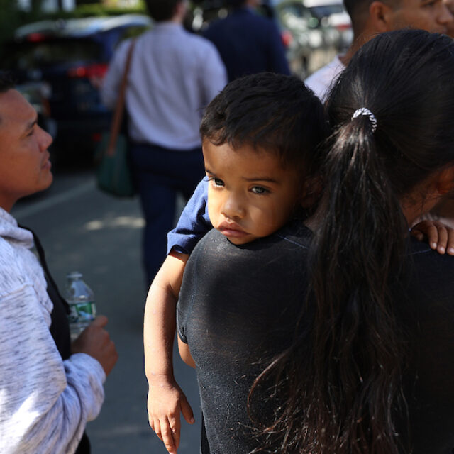 Martha's Vineyard, MA - September 15: A mother and child spent some time outside the St. Andrew's Parrish House where migrants were being fed lunch with donated food from the community. Two planes of migrants from Venezuela arrived suddenly Wednesday night on Martha's Vineyard.