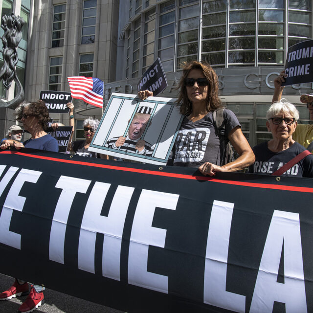 Protesters stand outside as Donald Trump's lawyers enter Brooklyn Federal Court on Tuesday, Sept. 20, 2022, in New York. Lawyers for Trump and for the Justice Department are to appear in federal court in Brooklyn on Tuesday before a veteran judge named last week as special master to review the roughly 11,000 documents — including about 100 marked as classified — taken during the FBI's Aug. 8 search of Mar-a-Lago.