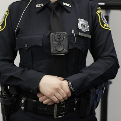 Newark Police officer Veronica Rivera wears a body camera during a news conference at the Panasonic headquarters unveiling body cameras for officers, Wednesday, April 26, 2017, in Newark, N.J. The cameras, which will be worn by officers as part of a federal monitoring agreement, are provided by Panasonic. Newark's police were put under a five-year federal monitoring program last year after a Department of Justice investigation found officers made unconstitutional street stops and engaged in the excessive use of force.