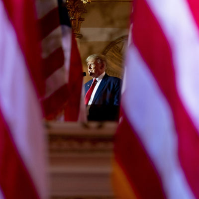 Former President Donald Trump, seen in reflection, announces he is running for president for the third time as he speaks at Mar-a-Lago in Palm Beach, Fla., Tuesday, Nov. 15, 2022.