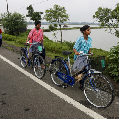 Village girls walk with bicycles they received from their school under a government scheme in Malancha, South 24 Pargana district, India, Wednesday, Oct. 20, 2021.