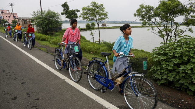 Village girls walk with bicycles they received from their school under a government scheme in Malancha, South 24 Pargana district, India, Wednesday, Oct. 20, 2021.
