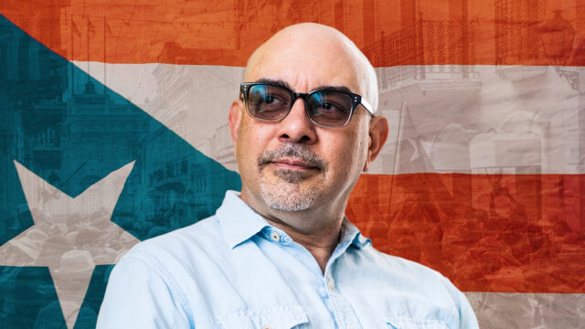 Headshot of Amílcar Antonio Barreto in front of the Puerto Rican flag.