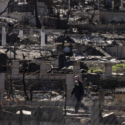 FEMA’s search and rescue team member works in a residential area consumed by a wildfire in Lahaina, Hawaii.
