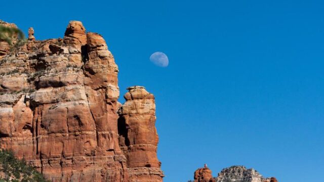 The moon rises over Sedona's iconic sandstone towers on June 6, 2023.