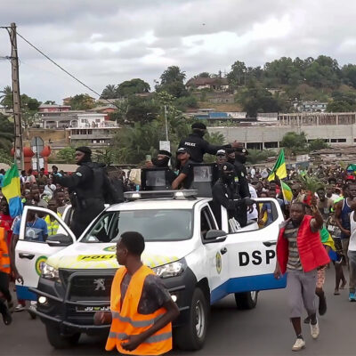 This video grab shows coup supporters cheering police officers in Libreville, Gabon, Wednesday Aug. 30, 2023. Mutinous soldiers speaking on state television announced that they had seized power in and were overturning the results of a presidential election that had seen Gabon President Ali Bongo Ondimba extend his family’s 55-year hold on power. ( AP Photo/Betiness Mackosso)