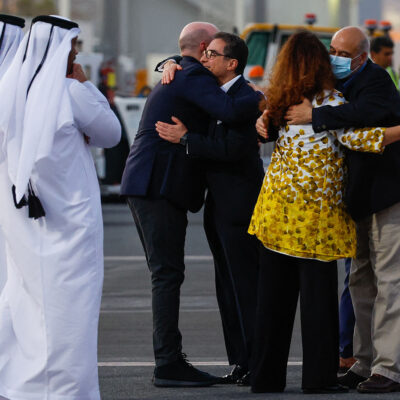 US citizens Siamak Namazi (C-with glasses) and Morad Tahbaz are greeted upon their arrival at the Doha International Airport in Doha on September 18, 2023.