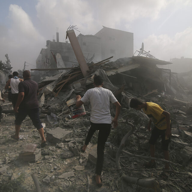 Palestinians look for survivers in buildings destroyed in the Israeli bombardment of the Gaza Strip in Rafah, Sunday, Oct. 22, 2023.