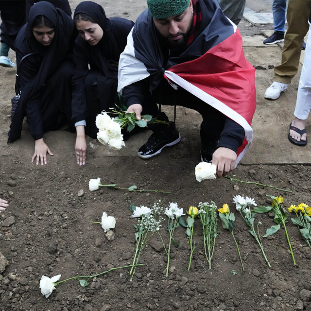 Muslim community members leave flowers at Wadea Al Fayoume's grave in LaGrange, Ill., Monday, Oct. 16, 2023.