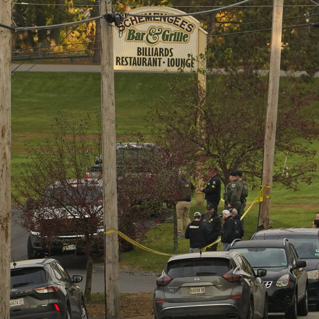 Law enforcement gather outside Schemengee's Bar and Grille, Thursday, Oct. 26, 2023, in Lewiston, Maine.