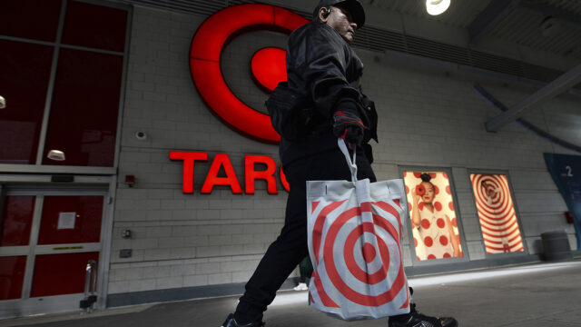 A shopper walks past the Target store logo affixed to the Harlem location, one of 9 locations set to close announced by discount retailer, New York, NY, September 27, 2023.