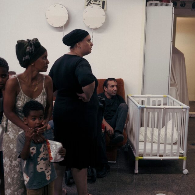 Civilians take refuge in a bomb shelter during a missile attack in Ashkelon, Israel.