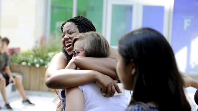 Tashila Peter, SSH'19, gives Kathryn Aragon, S'19, a hug after returning back to school during Fall Fest '15 at Northeastern University on Sept. 7, 2015.