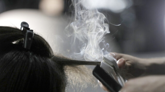 Steam rises as a hair stylist works on a model prior to a show displaying the Tom Ford collection during Fashion Week on Feb. 6, 2019, in New York.