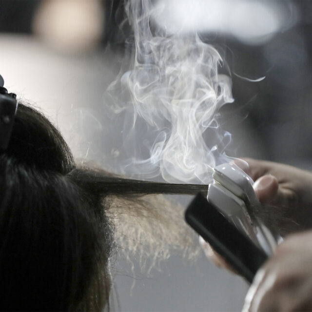 Steam rises as a hair stylist works on a model prior to a show displaying the Tom Ford collection during Fashion Week on Feb. 6, 2019, in New York.