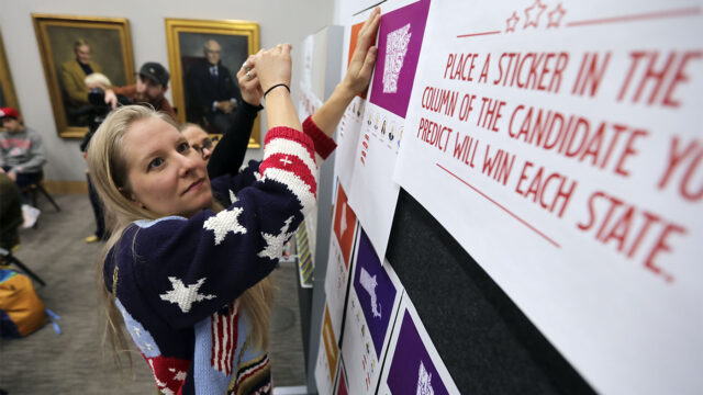 Molly Wheeler, Hinckley Institute of Politics managing director of community outreach, sets up an interactive candidate prediction board during an election watch party at the Hinckley Institute of Politics in Salt Lake City, Tuesday, March 3, 2020.