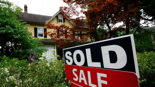 A sale sign stands outside a home in Wyndmoor, Pa., Wednesday, June 22, 2022.