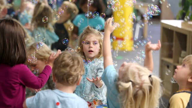 Lova Robinson, 4, plays with bubbles at the Bumble Art Studio day care in Astoria, Ore., Friday, Sept. 2, 2022.