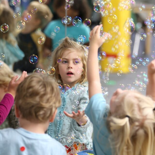 Lova Robinson, 4, plays with bubbles at the Bumble Art Studio day care in Astoria, Ore., Friday, Sept. 2, 2022.