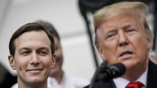 Jared Kushner(left) smiling as Donald Trump (right) speaks.