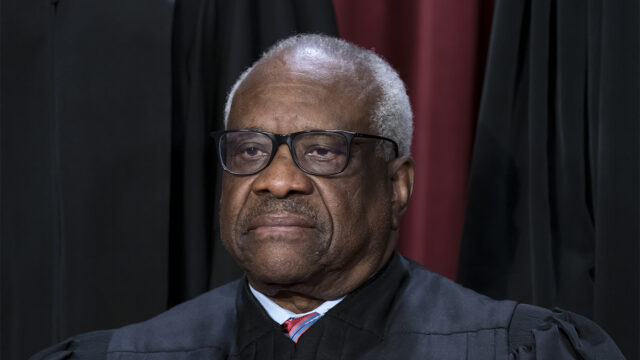 FILE - Associate Justice Clarence Thomas joins other members of the Supreme Court as they pose for a new group portrait, at the Supreme Court building in Washington, Oct. 7, 2022. Thomas is acknowledging that he took three trips last year aboard a private plane owned by Republican megadonor Harlan Crow. It’s the first time in years that Thomas has reported receiving hospitality from Crow. (AP Photo/J. Scott Applewhite, File)