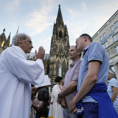 FILE - Same-sex couples take part in a public blessing ceremony in front of the Cologne Cathedral in Cologne, Germany, on Sept. 20, 2023. Pope Francis has formally approved allowing priests to bless same-sex couples, with a new document released Monday Dec. 18, 2023 explaining a radical change in Vatican policy by insisting that people seeking God’s love and mercy shouldn’t be subject to “an exhaustive moral analysis” to receive it. (AP Photo/Martin Meissner, File)