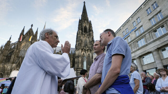 FILE - Same-sex couples take part in a public blessing ceremony in front of the Cologne Cathedral in Cologne, Germany, on Sept. 20, 2023. Pope Francis has formally approved allowing priests to bless same-sex couples, with a new document released Monday Dec. 18, 2023 explaining a radical change in Vatican policy by insisting that people seeking God’s love and mercy shouldn’t be subject to “an exhaustive moral analysis” to receive it. (AP Photo/Martin Meissner, File)