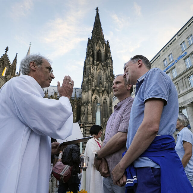 FILE - Same-sex couples take part in a public blessing ceremony in front of the Cologne Cathedral in Cologne, Germany, on Sept. 20, 2023. Pope Francis has formally approved allowing priests to bless same-sex couples, with a new document released Monday Dec. 18, 2023 explaining a radical change in Vatican policy by insisting that people seeking God’s love and mercy shouldn’t be subject to “an exhaustive moral analysis” to receive it. (AP Photo/Martin Meissner, File)