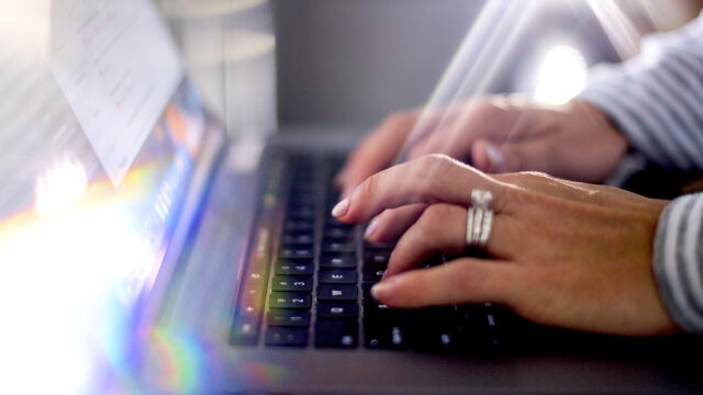 A person typing on a computer.