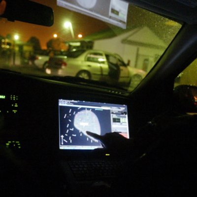 In this 2008 file photo, engineer Stephan Noetzel alerts a police officer to gunshots using ShotSpotter in East Palo Alto, Calif. Police and public officials nationwide continue to debate use of the technology.