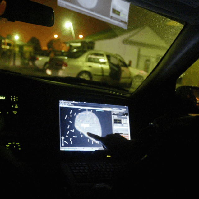 In this 2008 file photo, engineer Stephan Noetzel alerts a police officer to gunshots using ShotSpotter in East Palo Alto, Calif. Police and public officials nationwide continue to debate use of the technology.