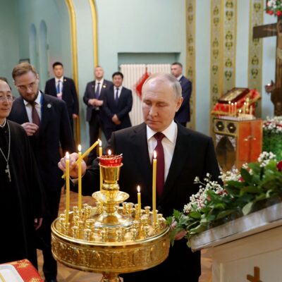Russian President Vladimir Putin photographed while visiting a church in Harbin, China. PHOTO CREDIT: ALEXANDER RYUMIN/PRESS POOL