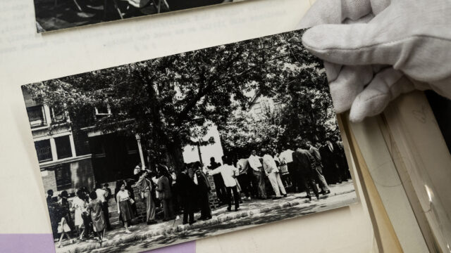 Molly Brown, Northeastern reference and outreach archivist, looks through photos of the Saint Marks Freedom School Stay-out in 1964 from the Phyllis Ryan papers which are now part of the Snell Library archives on Thursday, Feb. 15, 2024. Photo by Alyssa Stone/Northeastern University