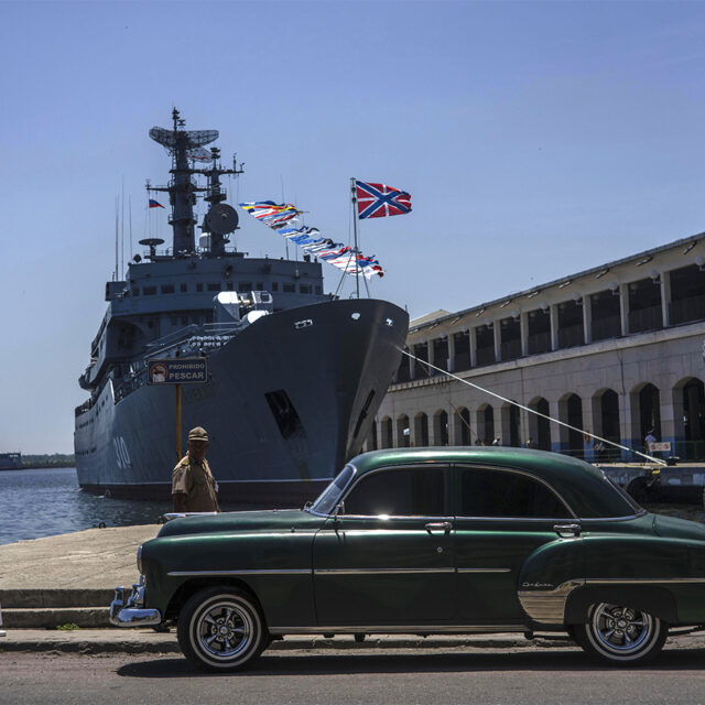 image of a Cuban sailor walking past the Russian Navy training ship, Perekop, in Havana Bay, Cuba, Tuesday, July 11, 2023. (AP Photo/Ramon Espinosa)