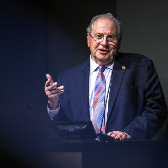 image of robert deleo behind podium