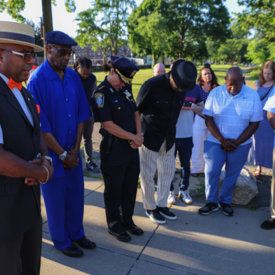 Student Minister Randy Muhammad, from Muhammad Mosque Number 11, gave a prayer during a community walk against violence with police officials including Commissioner Michael Cox at Harambee Park playground.