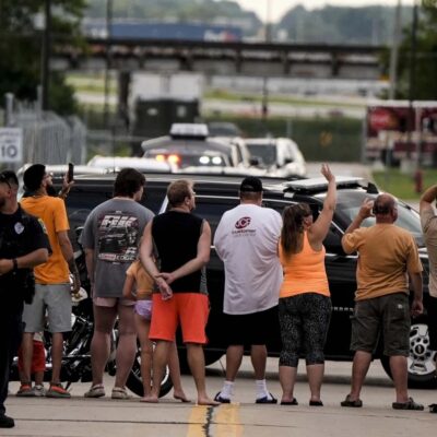 Trump supporters waving to him as he arrives to the Milwaukee Mitchell International Airport ahead of the 2024 Republican National Convention.