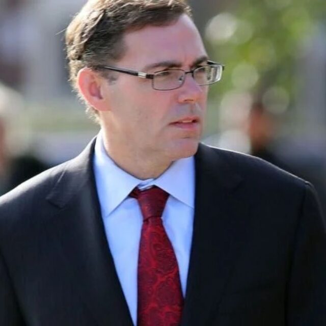 Hank Brennan photographed in 2018 outside Saint Monica's Church in South Boston as a funeral service was held for James 
