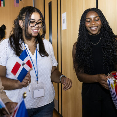 Josiehanna Colon and Christly Bright-Agindotan and out flags during the LatinX and Hispanic heritage month celebration at the Bruce Bolling building in Roxbury on Thursday, Oct. 3, 2024. Photo by Alyssa Stone/Northeastern University